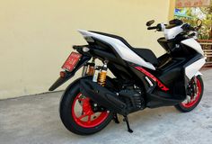 a white and red motorcycle parked in front of a building