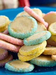 a blue plate topped with cookies covered in powdered sugar