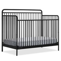 a black crib with white sheets on the bottom and side rails, against a white background