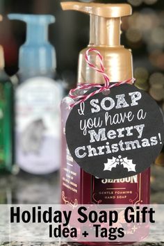 a bottle of soap sitting on top of a counter next to a tag that says, i soap you have a merry christmas