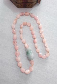 "Pink Morganite Long Necklace with  Garde A Burma Jade Vase Carving Bead Necklace Length: 29\" Morganite Beads : Assorted Size  Green Jadeite Carved Bead : 40x25mm  The necklace is made by natural morganite and Grade A Green Jade hand carved bead.  All the beads are hand knotted with silk thread. The carving is absolutely beautiful and attractive. And it is easy to wear in any occasion.  It will be a special gift for your loved one. All jewelry comes with Kennaries jewellery signature gift bag. Please feel free to message me if you want to see more photos or make any modifications on the necklace. Free worldwide shipping P.S the color of the stone may vary from monitor to monitor. Please note there is no photo editing used on any photos." Pink Adjustable Jade Jewelry, Pink Jade Jewelry With Natural Stones, Pink Jade Jewelry For Gift, Pink Jade Jewelry Gift, Pink Jade Jewelry As A Gift, Pink Hand-strung Necklace As Gift, Pink Hand-strung Necklace For Gift, Elegant Pink Jade Jewelry, Jade Single Strand Beaded Necklace Gift