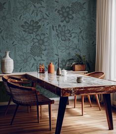 a dining room table with chairs and vases on it