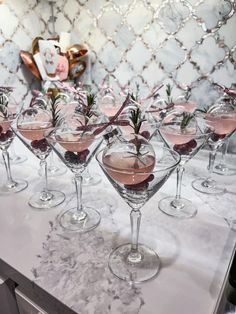 there are many wine glasses with different types of drinks in them on the counter top