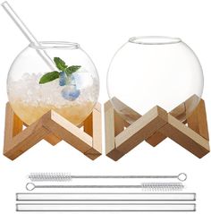 two fishbowes with straws and drinks in them, one is filled with ice