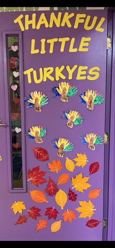 a purple door decorated with colorful leaves and words that say, thank little turkeys