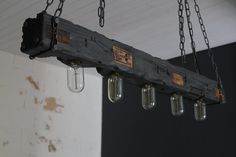 an old wooden beam with mason jars hanging from it