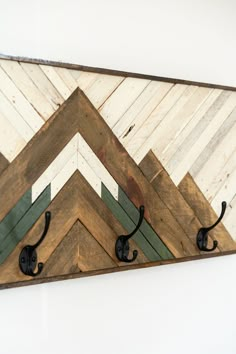 a wall mounted coat rack made out of wood and metal