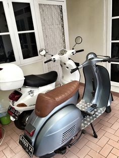 a motor scooter parked in front of a window