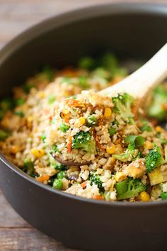 broccoli, rice and other vegetables are mixed together in a skillet