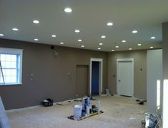 an empty room is being remodeled with lights on the ceiling and other items scattered around