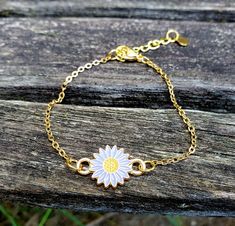 "This bracelet is perfect for anyone! You can choose your color: lavender, white, aqua, pink, or yellow. The metal is a gold color. The flower measures 1/2\" wide. The bracelet has an extender on it so it is adjustable, and it has a heart charm at the end. Perfect for a Mom gift, for a Christmas gift, anniversary, or a birthday. All jewelry items come in a gift box." Puzzle Guest Book, Wood Guest Book, Turquoise Rose, Daisy Bracelet, Memory Locket, Personalized Gift Wrap, Metal Charm, Bridesmaid Gift, Stainless Steel Chain