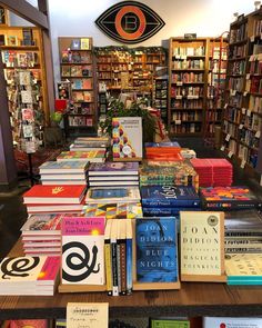 many books are stacked on top of each other in front of a book store display