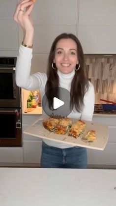 a woman holding a tray with food on it