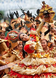 a group of people dressed in costumes and headgear at a carnival or festival