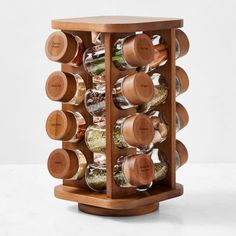 a wooden spice rack filled with lots of spices