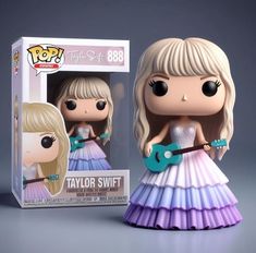 a pop vinyl doll with a guitar in her hand and a box behind it that says taylor swift