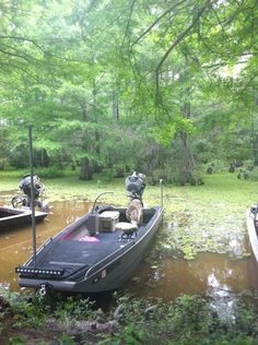 several boats are docked in the muddy water