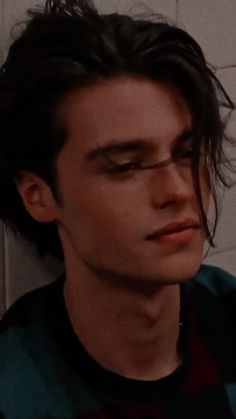 a close up of a person with long hair in a bathroom near a tile wall