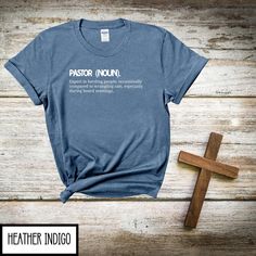 Looking for the perfect way to say "Thanks for keeping us all spiritually on track"? This "Pastor" definition t-shirt has got you covered! Ideal for Pastor Appreciation Day, Sunday morning sermons, or just a little light-hearted fun, this shirt defines exactly what makes a pastor... well, a pastor! Gildan 64000 Unisex Soft Style T-shirt Material Solids:  100% ring spun cotton Sport Grey & Antique Heather:  90% cotton, 10% Polyester Heathers:  65% polyester, 35% Cotton How to order 1. Please check and review all photos. 2.Choose your shirt color from the drop-down menu  3.Select your shirt size from the drop-down and add one at time. 4.Check out all at once, when the correct quantity and color has been added. 5.It usually takes 1-3 business days to process your order.   About the shirt Unis Pastor Shirt, Pastor Appreciation Day, Christian Funny, Pastor Appreciation, Church Gifts, Pastors Appreciation, Gifts For Pastors, Christian Shirt, Style T Shirt