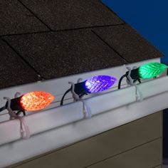 three different colored lights sitting on top of a roof