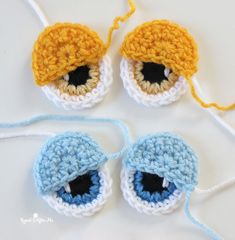 two crocheted eyeballs are sitting next to each other