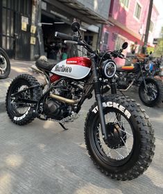 two motorcycles are parked on the street next to each other