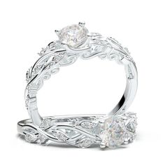 an intricately designed wedding ring set with a round diamond center and leaves on the band