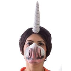 a woman with a fake nose has a unicorn horn on it's head and is wearing an orange shirt