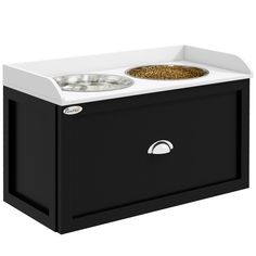 a black and white dog food station with two bowls on the top, one is empty