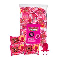 the pink candy bag is filled with heart shaped lollipops and two small bags