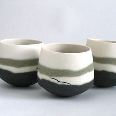 three white and black striped cups sitting next to each other