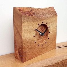 a wooden clock sitting on top of a table