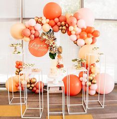 a table topped with lots of balloons and cake