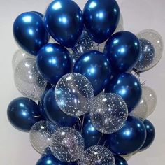 a bunch of blue and silver balloons