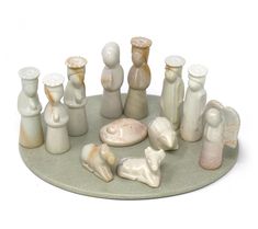 a group of ceramic figurines sitting on top of a plate