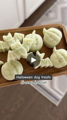 halloween dog treats are arranged on a wooden tray