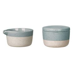 two blue and white bowls sitting next to each other