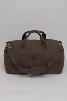 Nothing beats the simplicity and functionality of a good duffle bag—except maybe our Bumi Eco Duffel Bag, made with the good of the environment and people in mind! The perfect size for a spontaneous weekend getaway or when you need a little more room to haul daily gear for work or athletics.  Bag: 13"(H) x 20"(W) x 12"(D) Made with 12 to 14 oz Certified Fairtrade Organic cotton canvas Approximately 56L capacity Main compartment zippers with long pulls Internal zippered hanging pocket sized 9” (H Functional Brown Tote Weekender Bag, Functional Brown Everyday Travel Bag, Functional Brown Travel Bag For Everyday, Brown Everyday Duffle Bag, Brown Duffle Bag With Pockets For Travel, Brown Travel Duffle Bag With Pockets, Functional Brown Duffle Bag For Weekend Trips, Practical Brown Travel Bag For Everyday Use, Functional Brown Weekender Bag For Everyday Use