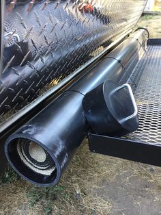 the back end of a truck with a large exhaust pipe on it's side