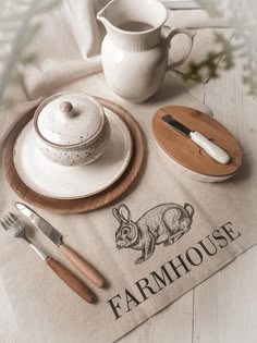 the table is set with dishes and utensils, including a teapot on top