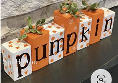 three pumpkin blocks with the word pumpkin painted on them