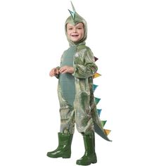 a little boy in a dinosaur costume with spikes on his head and legs, standing