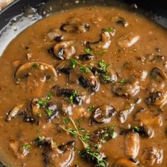 a skillet filled with mushroom soup and garnished with parsley