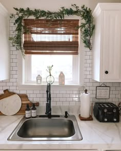 the kitchen sink is clean and ready to be used as a window sill for plants