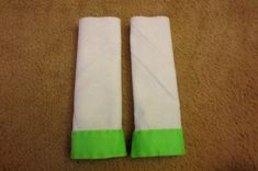 two white and green towels laying on the floor