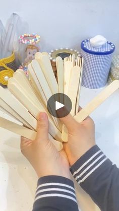 a person is holding wooden dows in their hands and they are making something out of wood