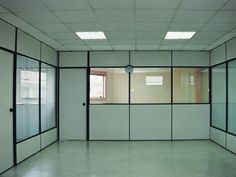 an empty room with white walls and black trim on the doors, windows and blinds