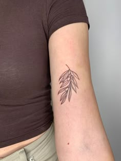 a woman's arm with a small tattoo on the left side of her body