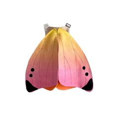 a large butterfly shaped object with two wings and black dots on it's face