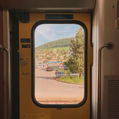 an open door on a train looking out at the town